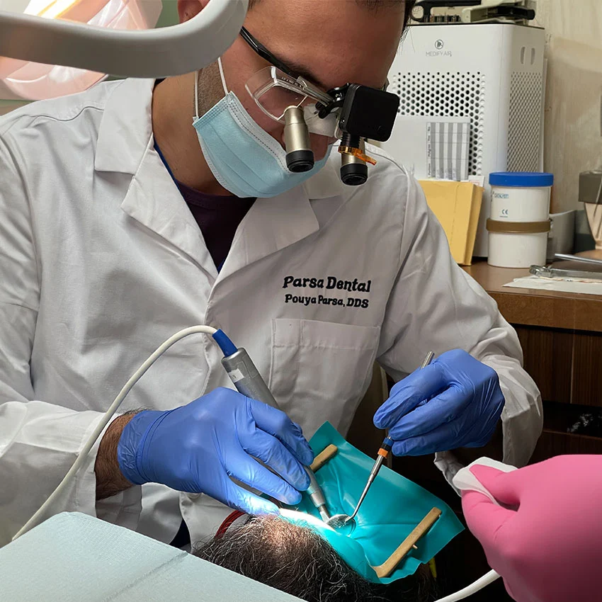 Expert dentist giving dental treatment to patient in Sun Valley, CA dental office
