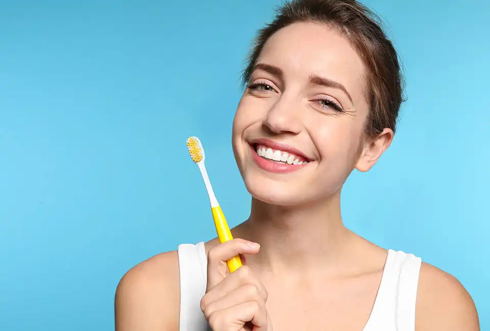 Patient holding tooth brush in Sun Valley, CA